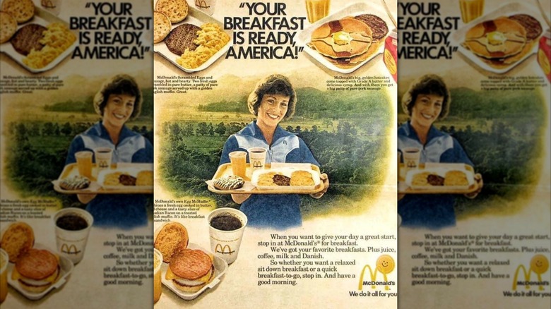 An original 1977 print advert for McDonald's first breakfast menu, featuring a smiling woman holding breakfast food and McDonald's breakfast dishes surrounding her