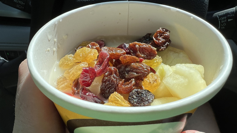 A pot of McCafé oatmeal, with dried fruit seen inside the pot