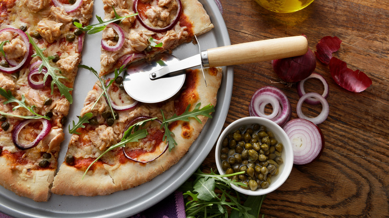 Pizza cutter on pizza