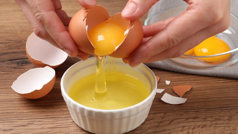 cracking an egg into ramekin