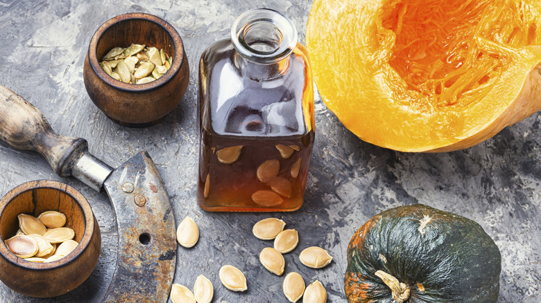 pumpkin and pumpkin seed oil on table