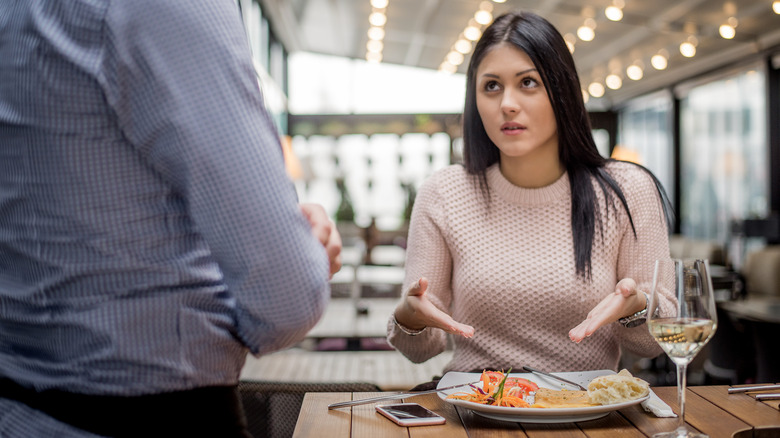 unhappy customer seated at restaurant