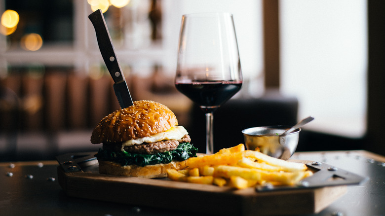 Burger fries and glass of red wine