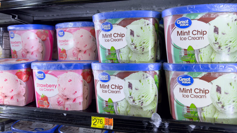 A row of Great Value mint chip and strawberry ice creams in the freezer at Walmart