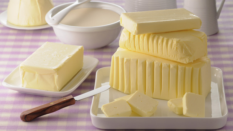 Blocks of butter on white dishes