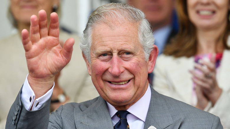 King Charles smiling and waving