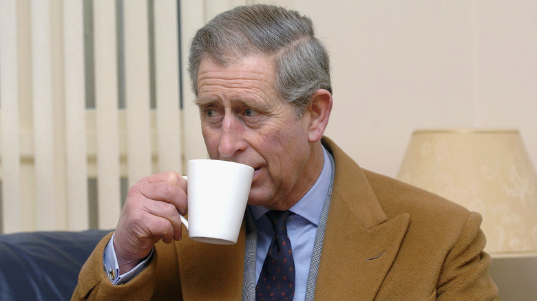 King Charles drinking from coffee mug