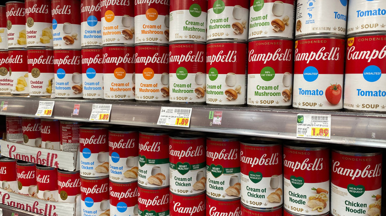 Cans of Campbell's soup on a shelf in a grocery store