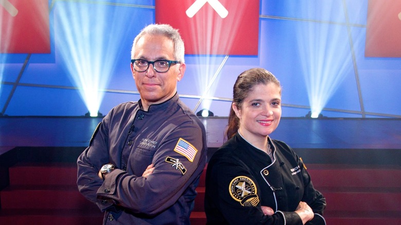 Alex Guarnaschelli and Geoffrey Zakarian pose for Iron Chef America: Tournament of Champions.