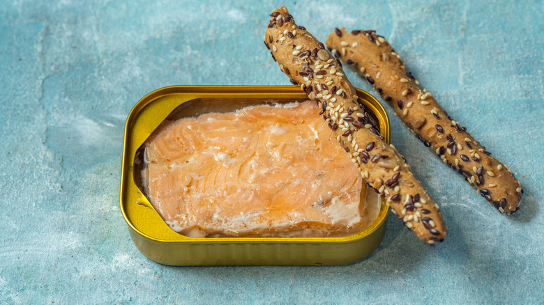 Open can on salmon with breadsticks.