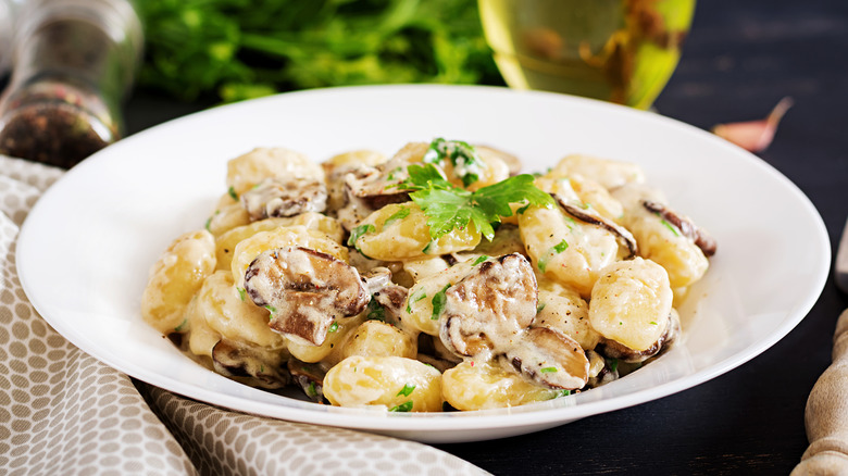 Gnocchi with a mushroom cream sauce and parsley in bowl