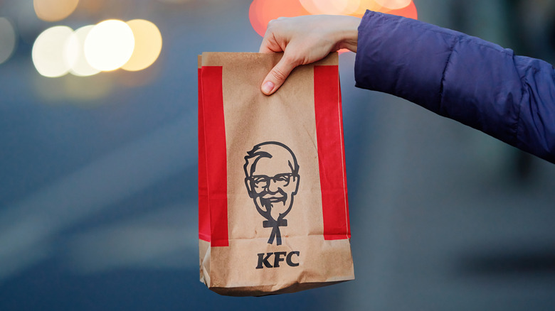 A person holding a bag from KFC