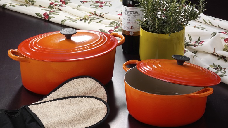 Two Le Creuset pots in the brand's classic orange color