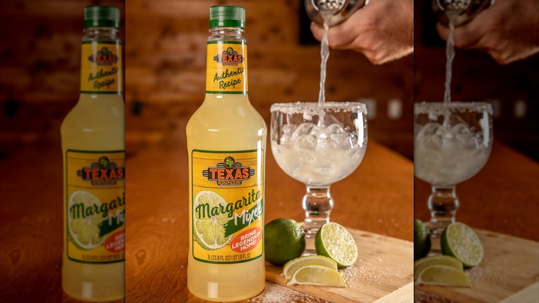 Pouring margarita into glass next to bottle of Texas Roadhouse margarita mixer