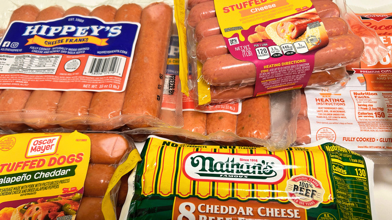 Variety of cheese-stuffed hot dogs in their packaging