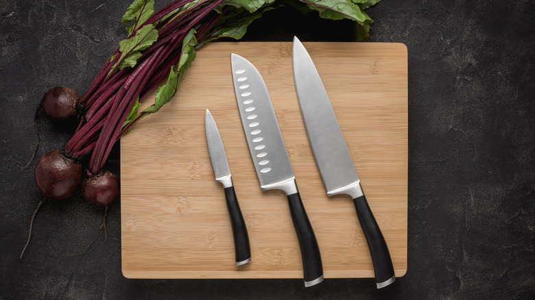 Chef's knife and other knives on a cutting board