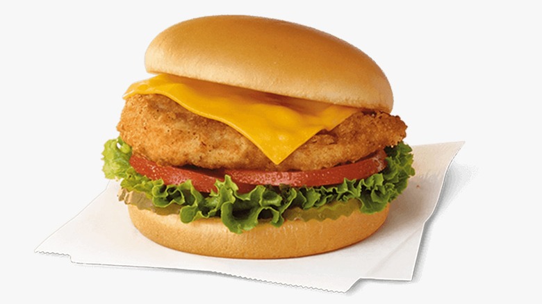 A Chick-fil-A Deluxe Sandwich on a napkin on a white background