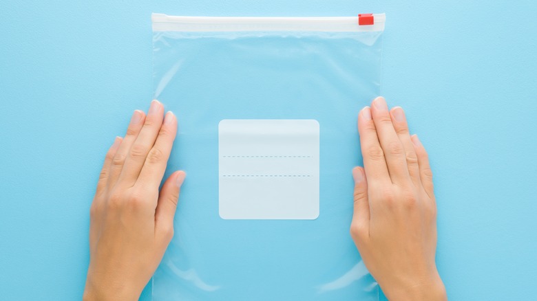 hands with zip-top bag