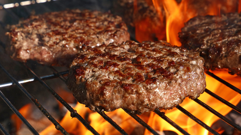 burgers cooking on grill
