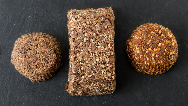 Large pieces of pemmican are lined up on a table.