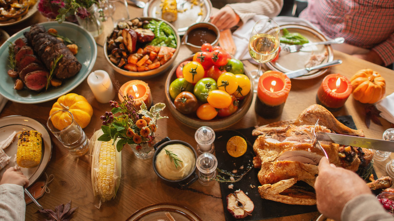 Festive family dinner table filled with diverse homemade dishes.