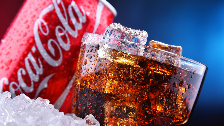 coca-cola in glass and bottle with ice