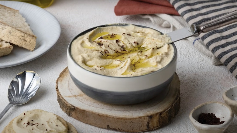 homemade hummus in bowl with bread 