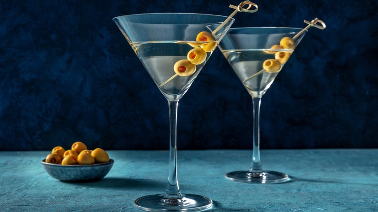 olives standing in martini glasses