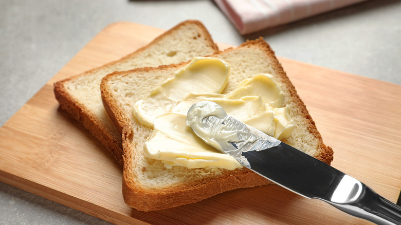 Spreading butter on toast 