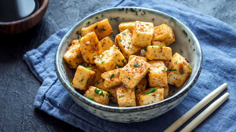 Seared tofu cubes in blue bowl