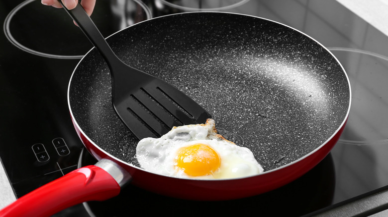 Fried egg in non-stick pan and spatula