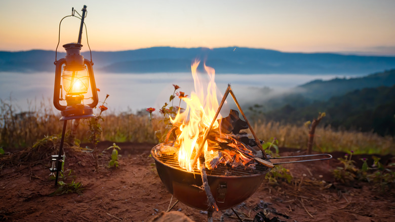 Campfire outdoors by a lake at sunset