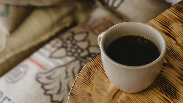 Mug of black coffee on wood table