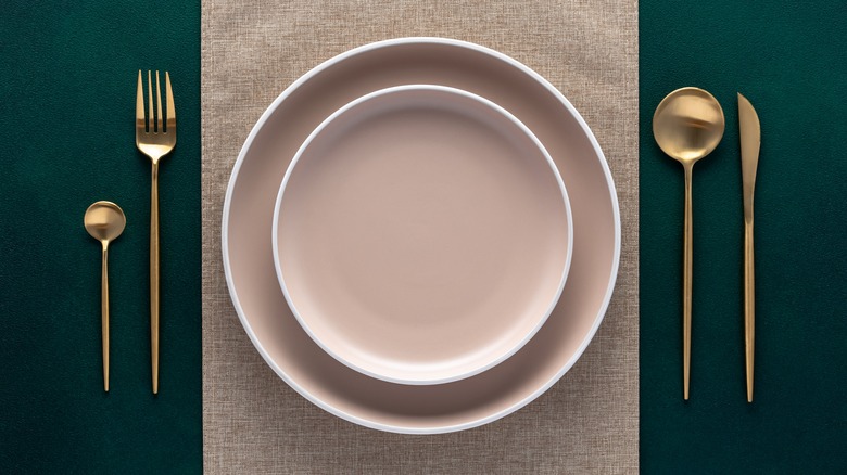 Two stacked pale pink plates