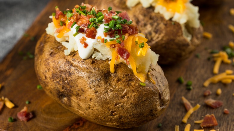A baked potato loaded with toppings