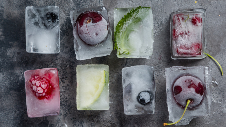 Fruit-infused ice cubes on a gray background