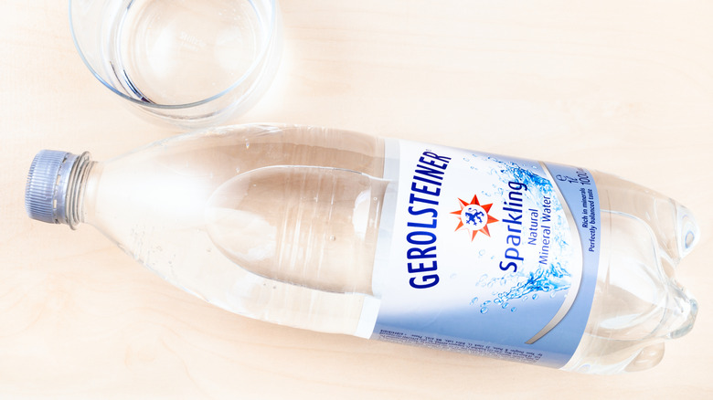 A glass and bottle of Gerolsteiner sparkling water