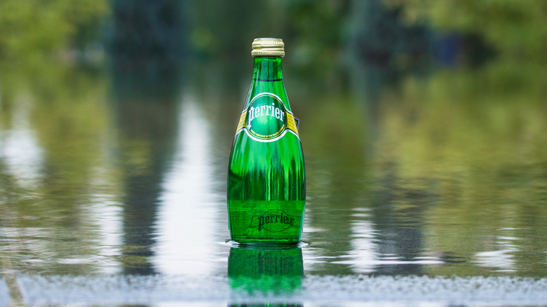 A bottle of Perrier sparkling water in river