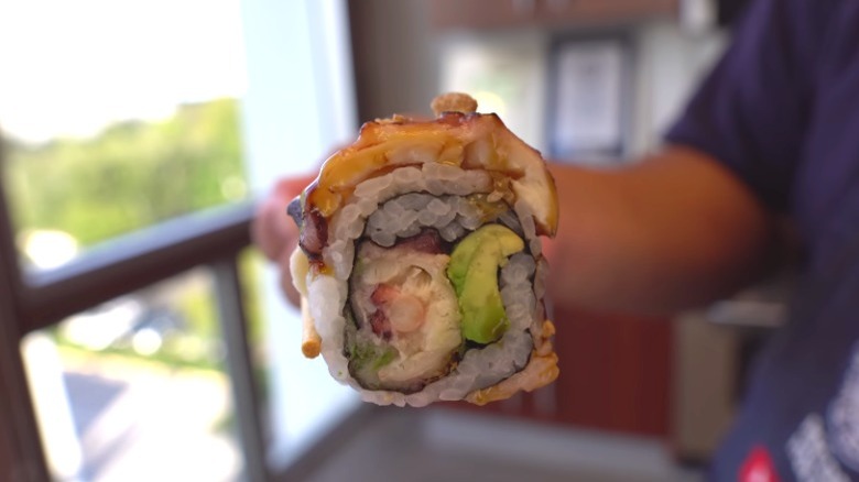 Personal holding a tako roll