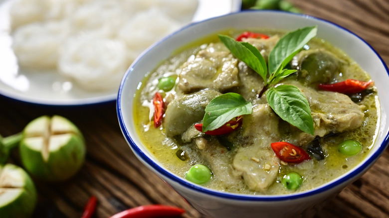 A bowl of green curry with Thai basil