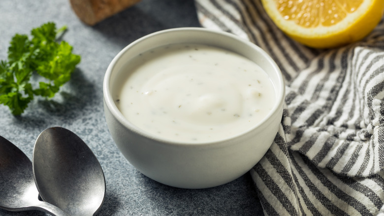 Bowl of ranch dressing with lemon garnish