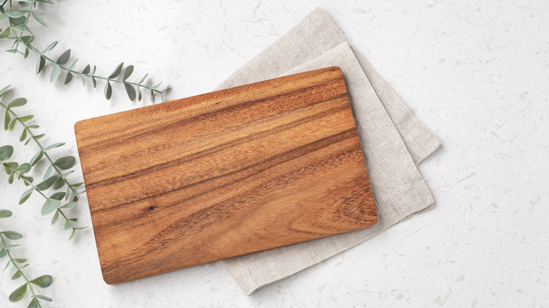 Wooden cutting board over napkin
