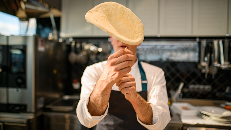 Chef throwing pizza dough