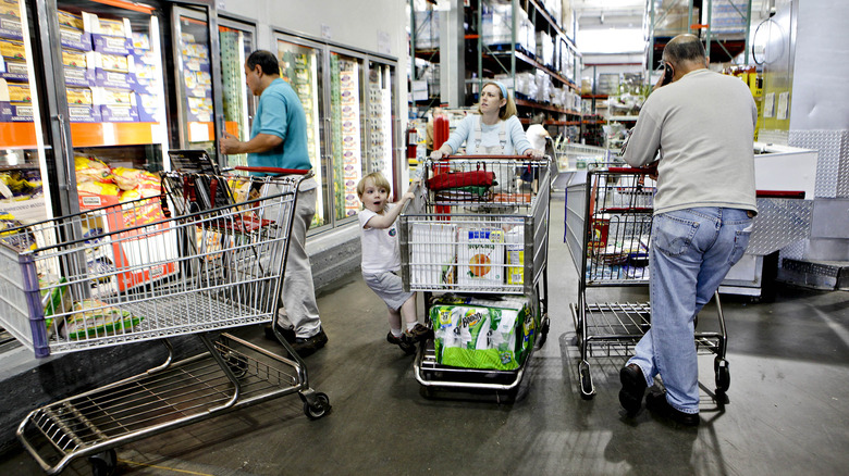 Costco shoppers with carts in the frozen food section
