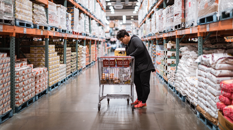 Shopper with grocery cart in Costco aisle