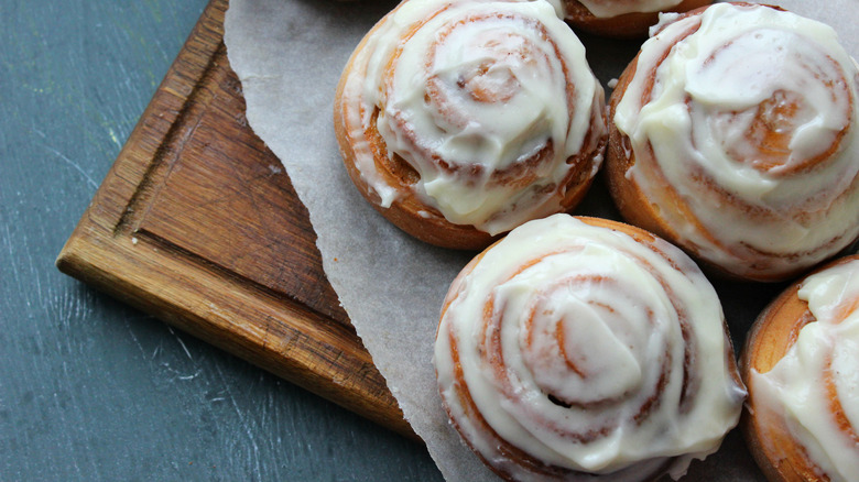Cinnamon buns on a wooden cutting board