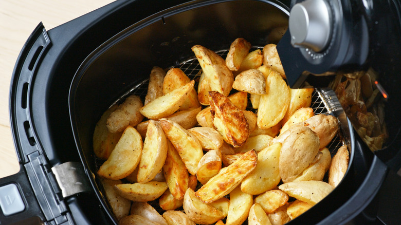 air fryer basket of potatoes