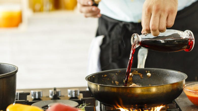 red wine being poured into pan
