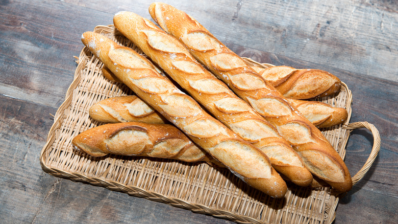 Wicker tray of baguettes on table