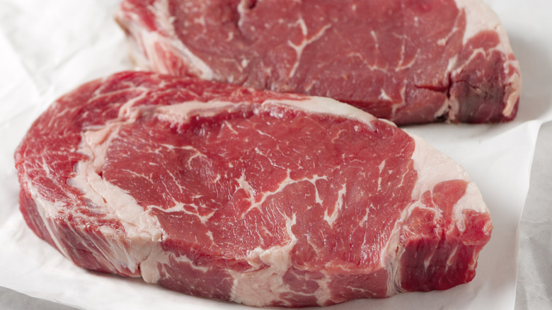 ribeye steaks on paper